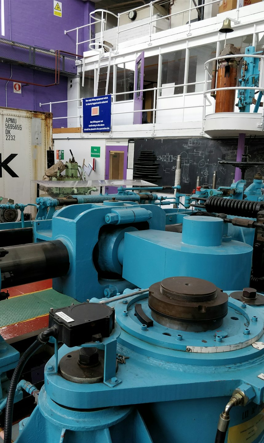 Heavy industrial machinery inside a metal workshop training facility.